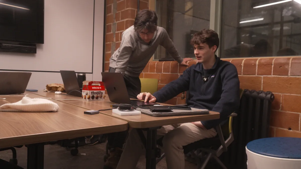 Two of the Lodavo team working at a computer