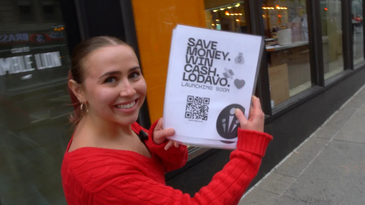 Ella from the Lodavo team holding a Lodavo poster